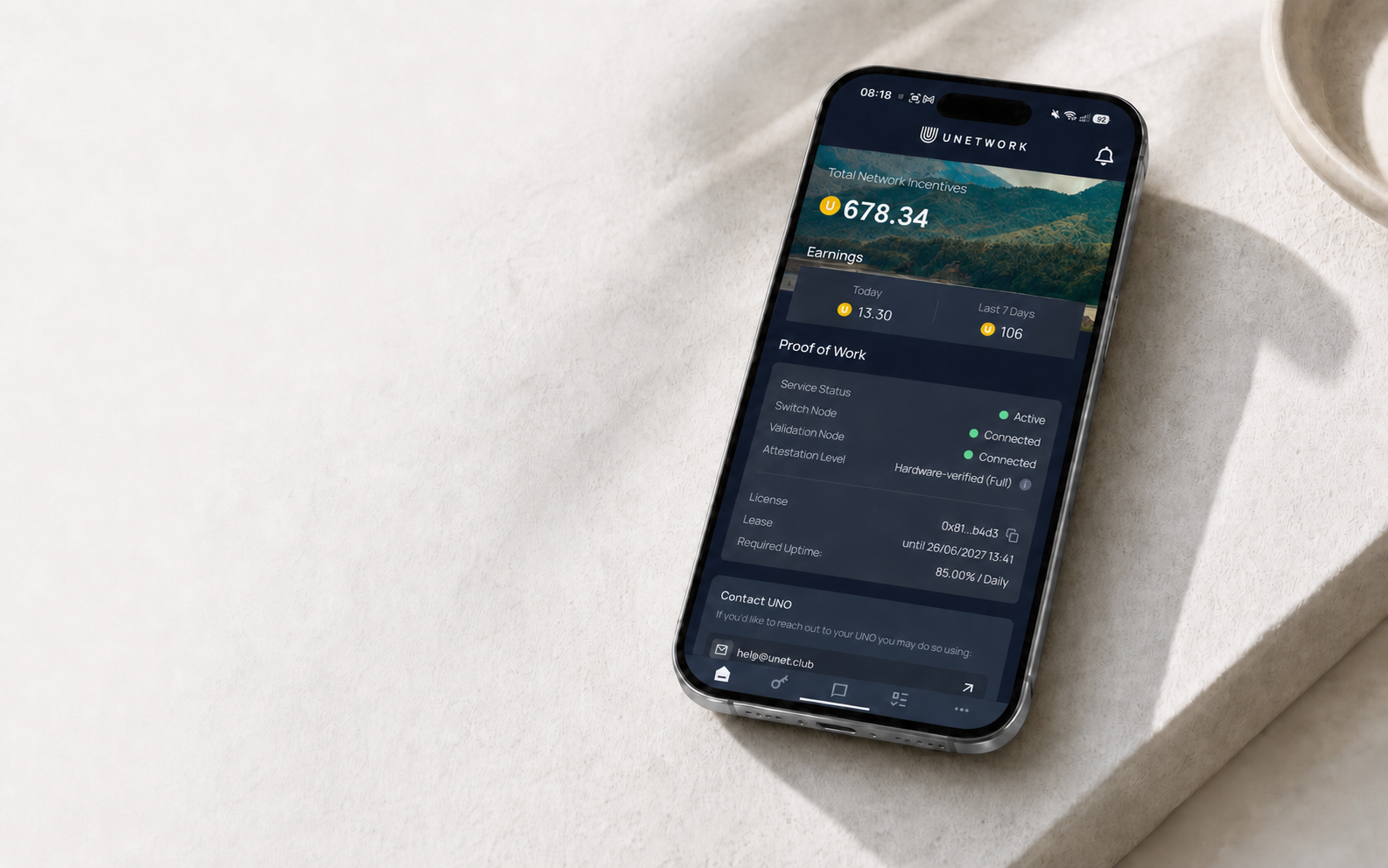 A phone displaying the Unetwork app dashboard with network incentives and connected Proof of Work status